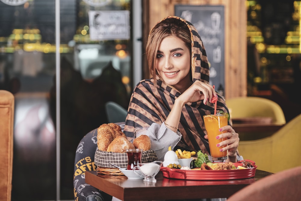 girl in white and black stripe long sleeve shirt holding orange plastic cup - customer loyalty program
